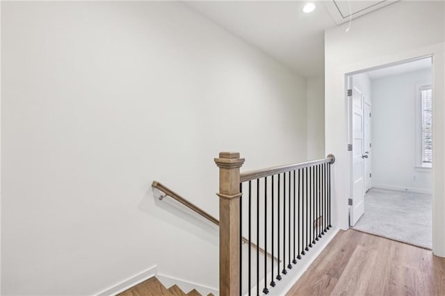 stairway featuring attic access, recessed lighting, baseboards, and wood finished floors