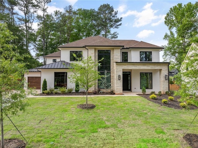 view of front of home featuring a garage and a front lawn