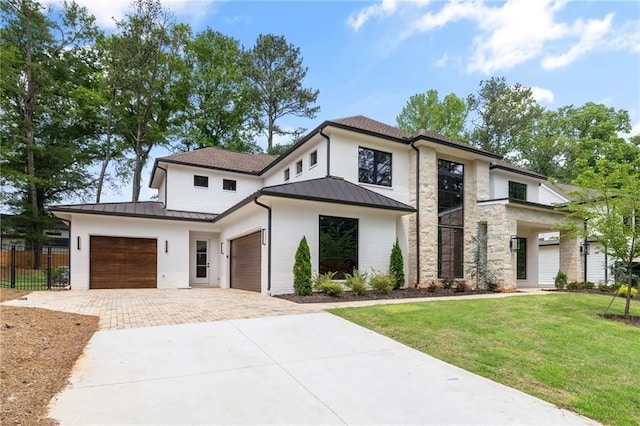 view of front of property featuring a garage and a front lawn