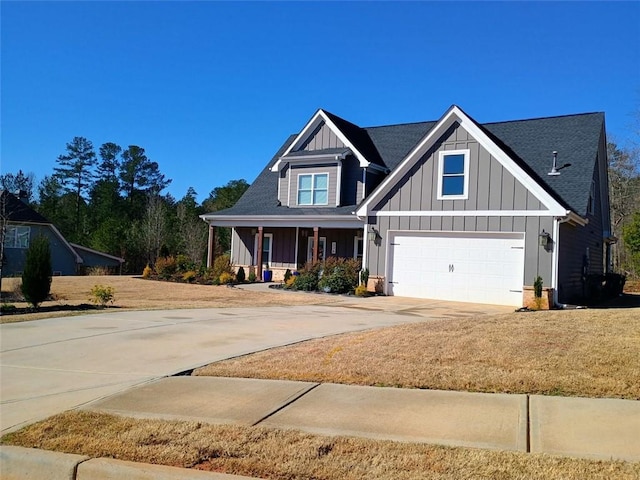 craftsman inspired home featuring an attached garage, covered porch, board and batten siding, and driveway