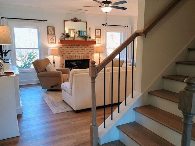 336 White Oak Way, Monroe, GA 30655 - living room featuring stairway, a ceiling fan, wood finished floors, and a brick fireplace
