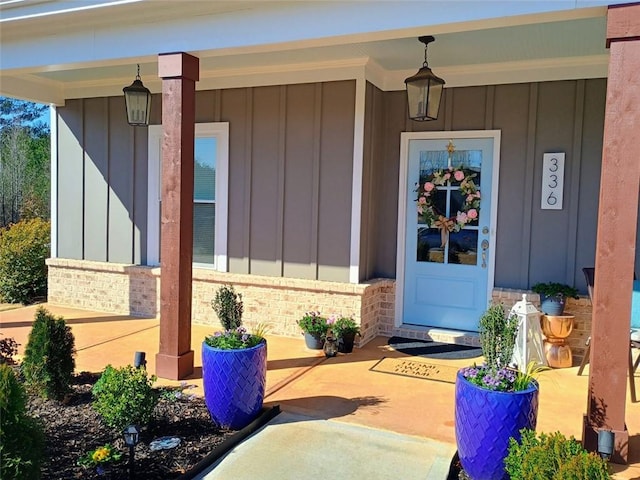 property entrance with brick siding, board and batten siding, and a porch