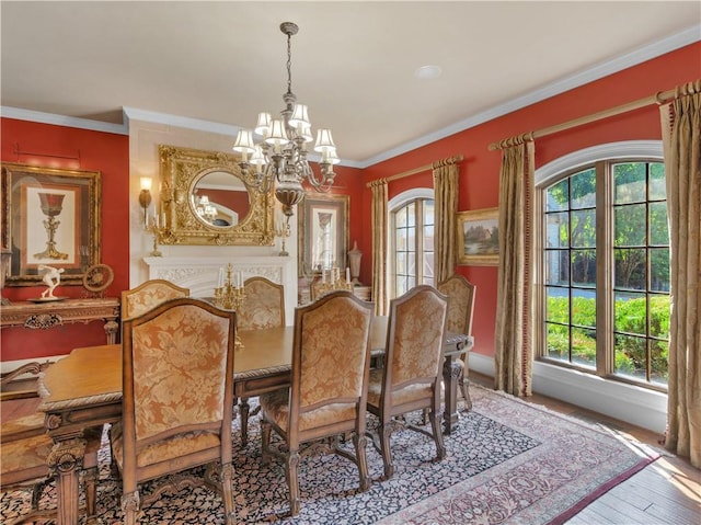 dining space featuring a notable chandelier, a healthy amount of sunlight, and ornamental molding