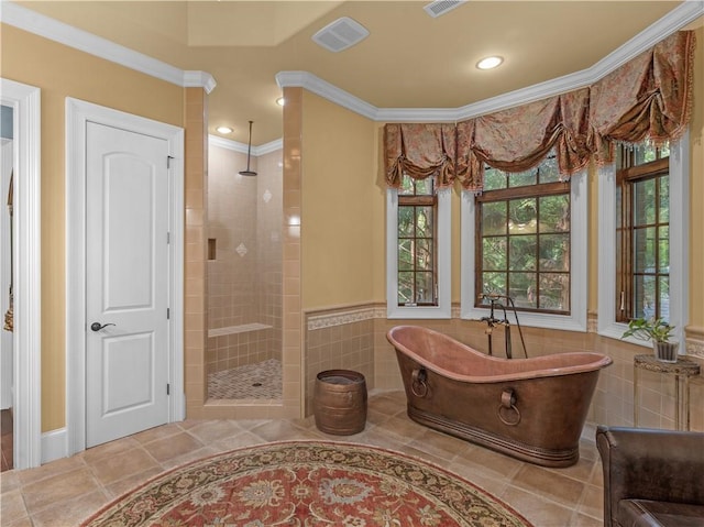 bathroom with a tile shower, a soaking tub, tile walls, and crown molding