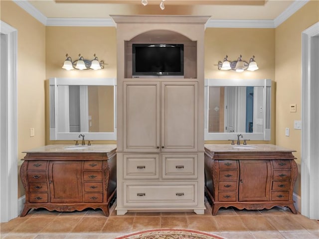 bathroom featuring two vanities, crown molding, and a sink