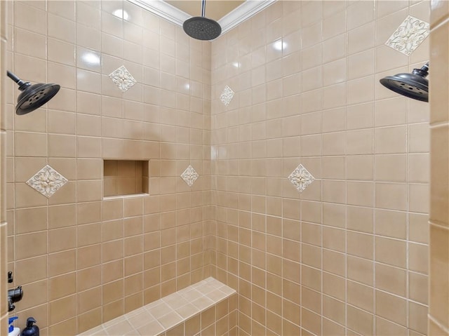 bathroom with ornamental molding and a tile shower