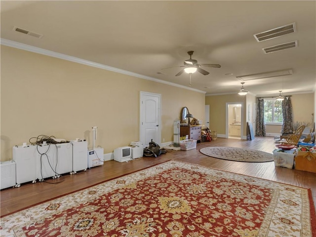 interior space featuring attic access, wood finished floors, and visible vents