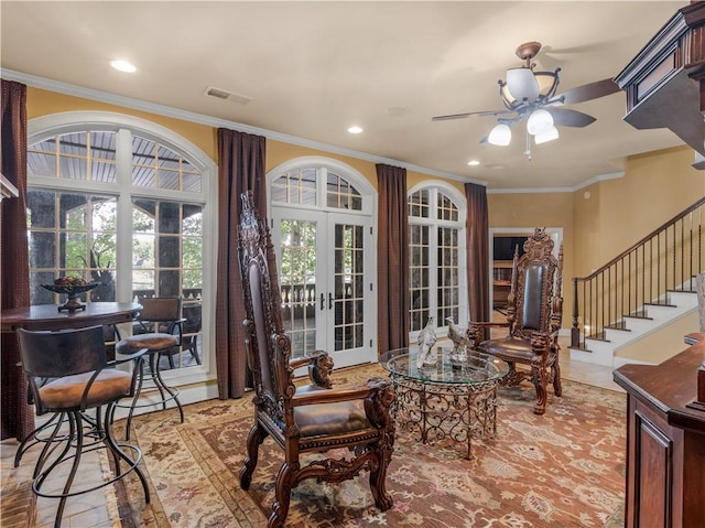 interior space featuring visible vents, stairway, crown molding, and a ceiling fan