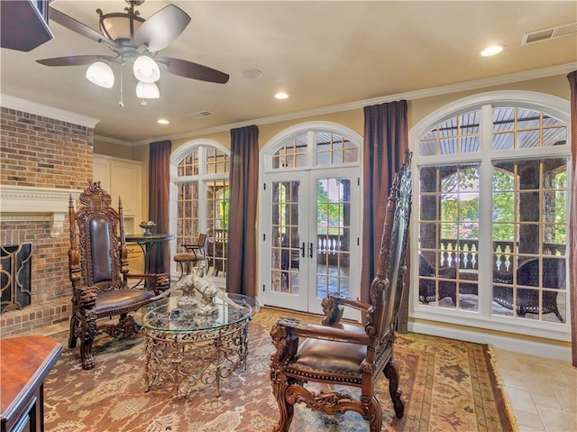 living area featuring visible vents, a fireplace, recessed lighting, french doors, and crown molding