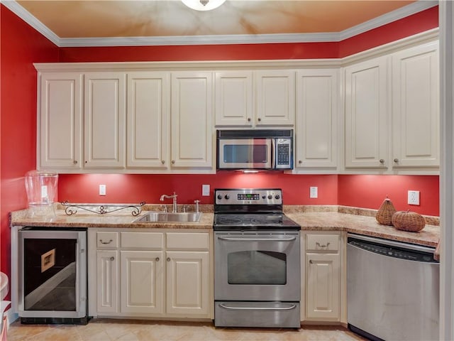 kitchen with beverage cooler, ornamental molding, a sink, appliances with stainless steel finishes, and light stone countertops