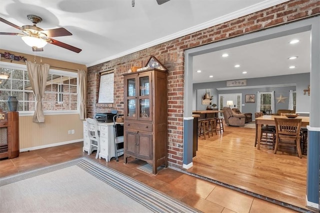 office space with a ceiling fan, recessed lighting, brick wall, and tile patterned floors