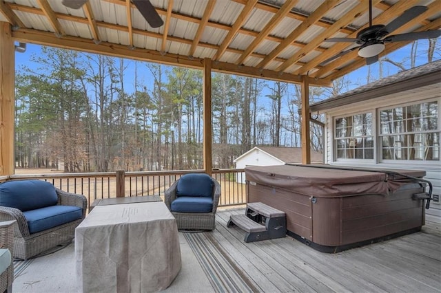 wooden terrace with a hot tub and a ceiling fan