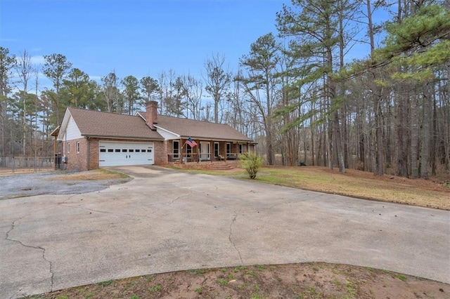 view of front facade with brick siding, a chimney, a porch, concrete driveway, and a garage