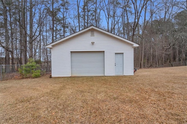 detached garage featuring fence