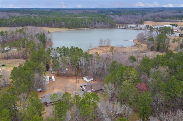 birds eye view of property with a water view and a wooded view