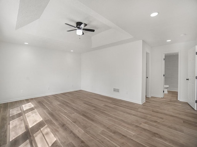 empty room with visible vents, recessed lighting, baseboards, and ceiling fan