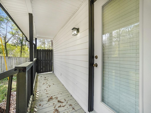 property entrance featuring a porch and fence