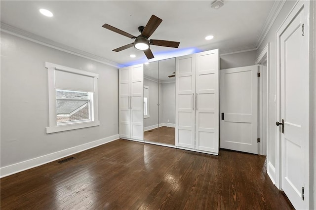 unfurnished bedroom with ceiling fan, ornamental molding, and dark hardwood / wood-style flooring