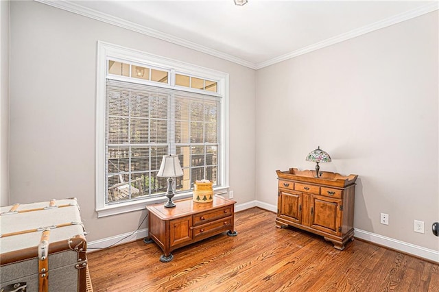 interior space with light wood-type flooring, baseboards, and crown molding