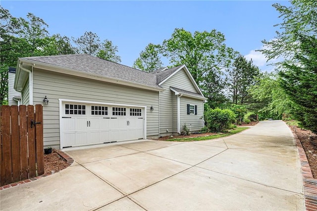 255 Heritage Creek Trl, Ball Ground, GA 30107 - view of side of home with concrete driveway, an attached garage, and a shingled roof