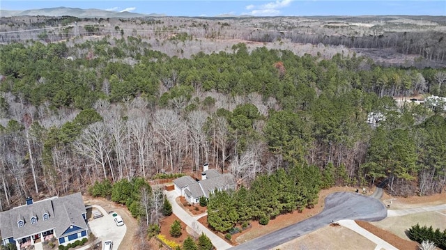 birds eye view of property with a wooded view