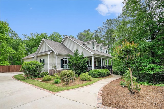 255 Heritage Creek Trl, Ball Ground, GA 30107 - view of side of home featuring a porch, fence, brick siding, and roof with shingles