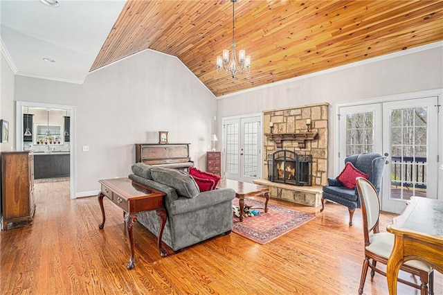 living room with wood finished floors, lofted ceiling, french doors, crown molding, and wooden ceiling