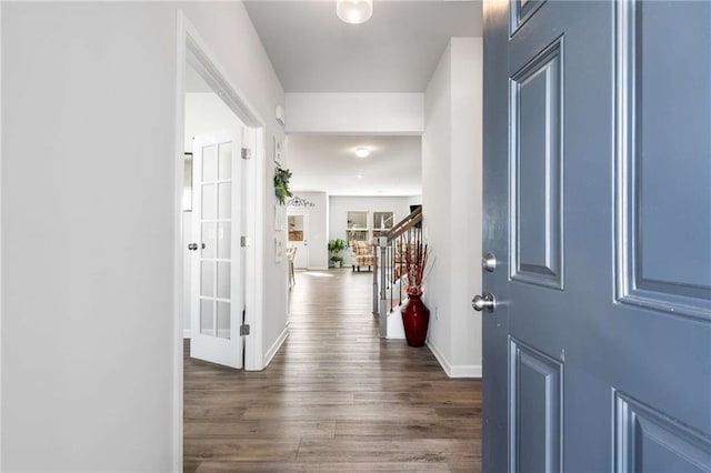 entryway featuring dark wood-style flooring, stairway, and baseboards