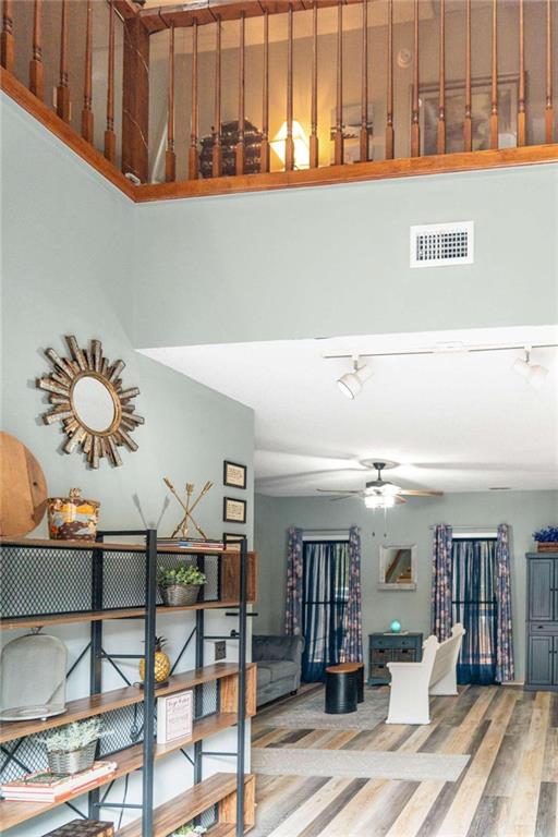 interior space with hardwood / wood-style flooring and ceiling fan