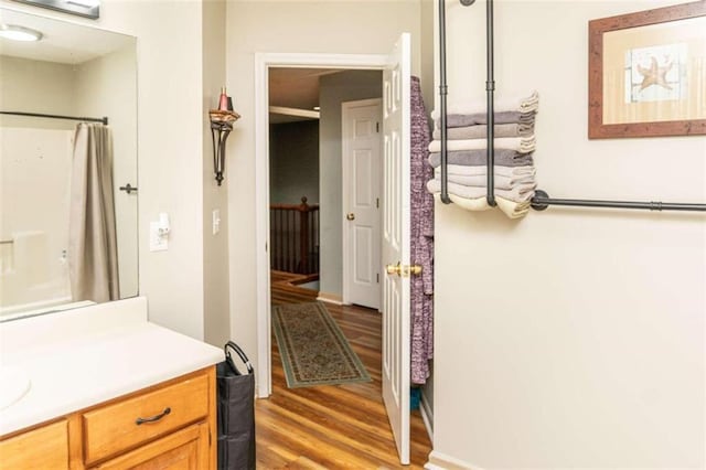 bathroom with vanity, curtained shower, and hardwood / wood-style floors