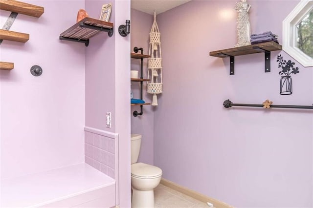 bathroom with tile patterned floors and toilet