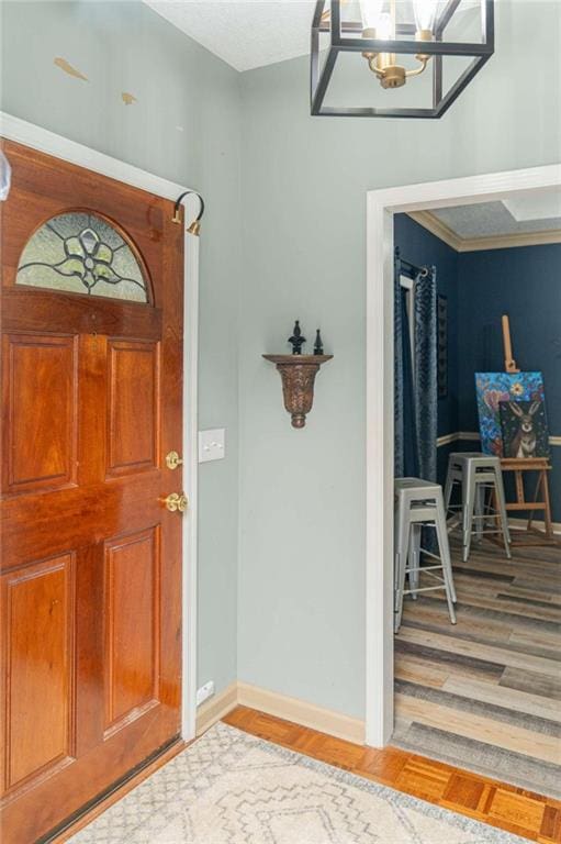 entrance foyer featuring an inviting chandelier and hardwood / wood-style flooring