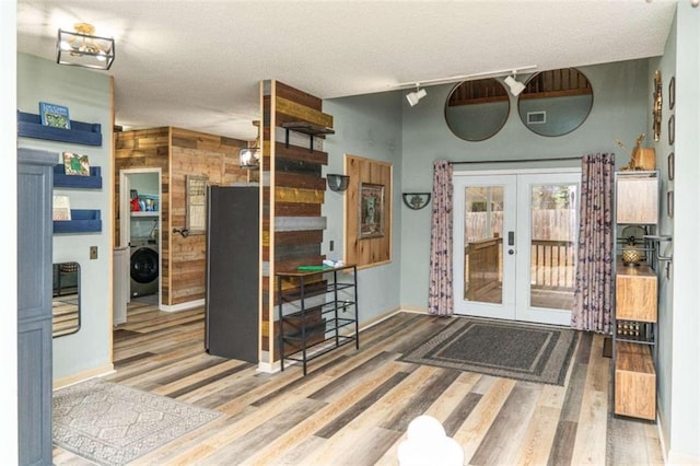 interior space featuring french doors and washer / dryer