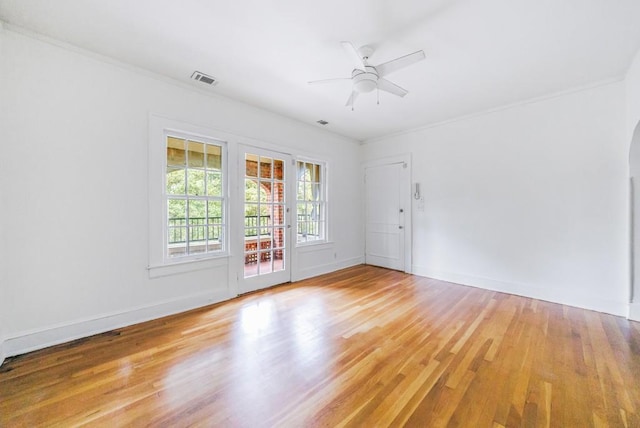 spare room featuring ceiling fan, crown molding, and light hardwood / wood-style flooring