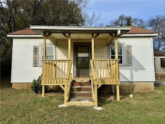 exterior space featuring a porch and a yard