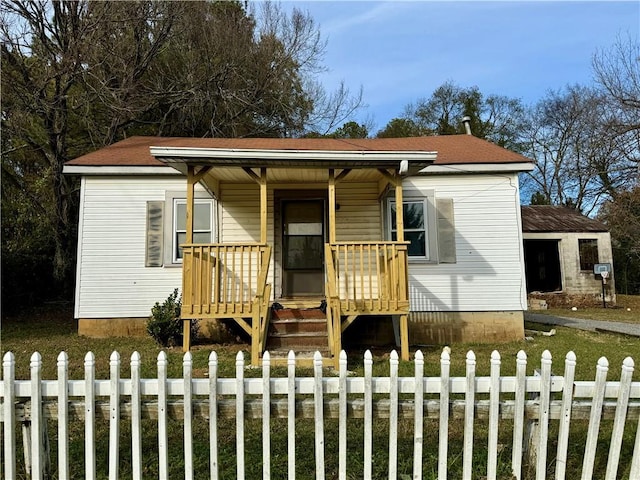 view of front of property with covered porch and a fenced front yard