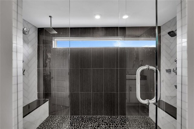 bathroom with a shower with shower door