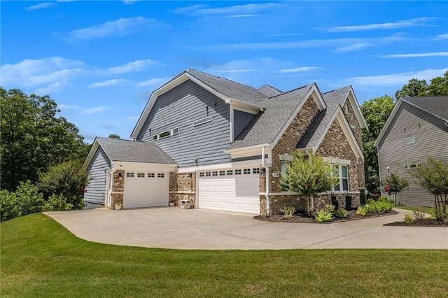 view of front of house featuring a garage and a front lawn