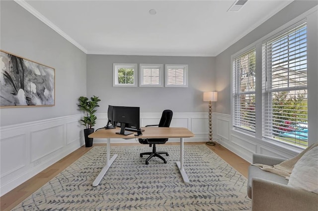 home office with crown molding and light hardwood / wood-style flooring