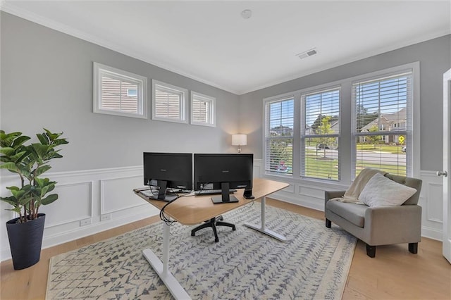 office space featuring hardwood / wood-style flooring and crown molding