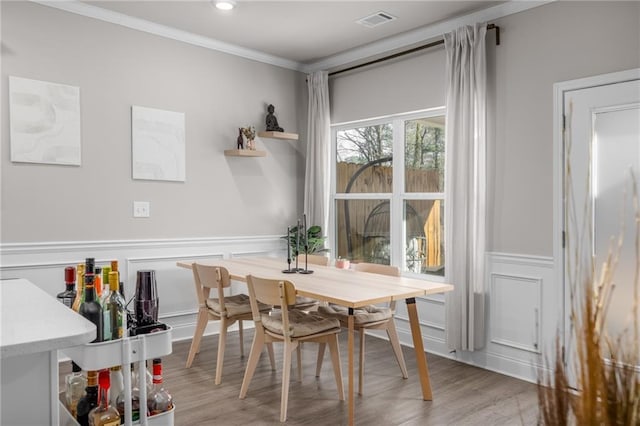 dining space featuring crown molding and hardwood / wood-style floors