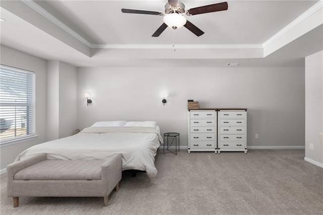 carpeted bedroom featuring crown molding, a raised ceiling, and ceiling fan