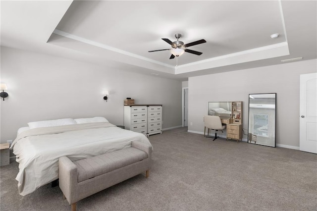 carpeted bedroom featuring crown molding, a tray ceiling, and ceiling fan