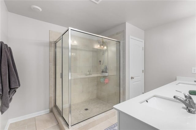 bathroom with vanity, an enclosed shower, and tile patterned flooring