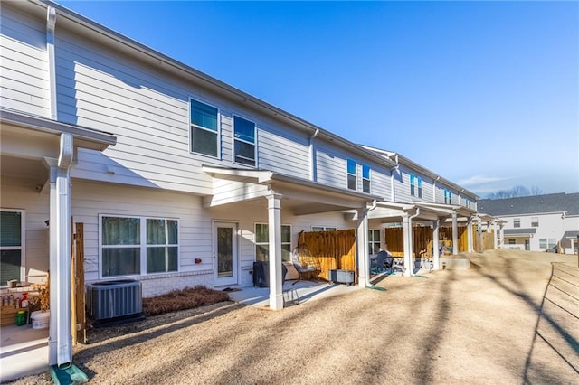 rear view of house featuring central AC unit and a patio area