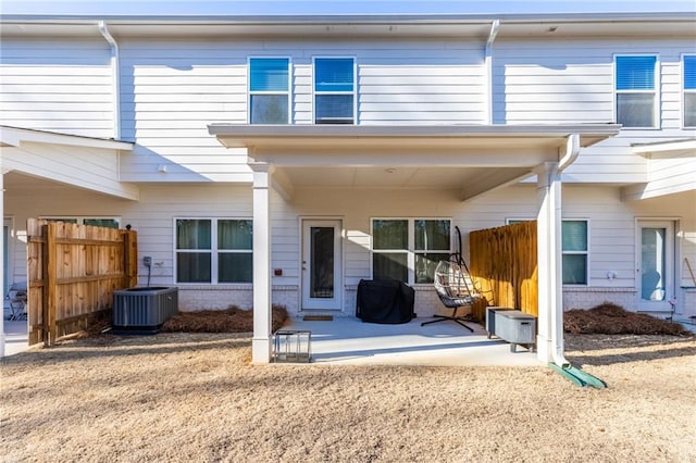 rear view of property featuring cooling unit and a patio area