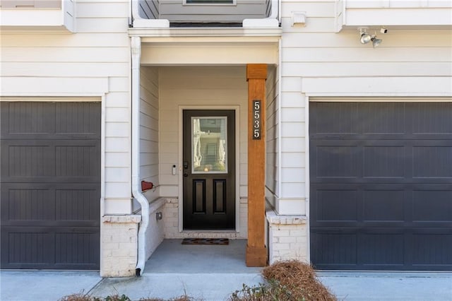 doorway to property with a garage