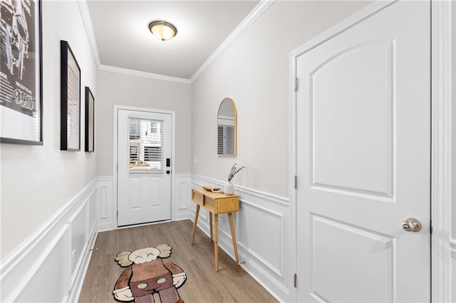 doorway to outside featuring ornamental molding and light hardwood / wood-style flooring