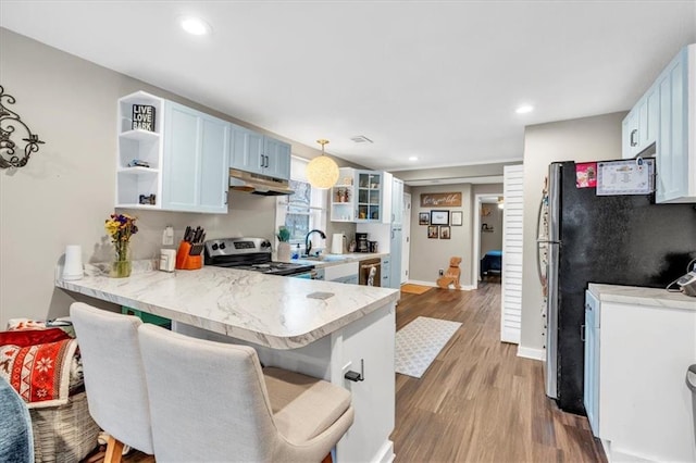 kitchen featuring open shelves, appliances with stainless steel finishes, a peninsula, and under cabinet range hood