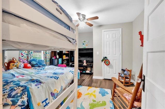bedroom with ceiling fan, baseboards, and wood finished floors